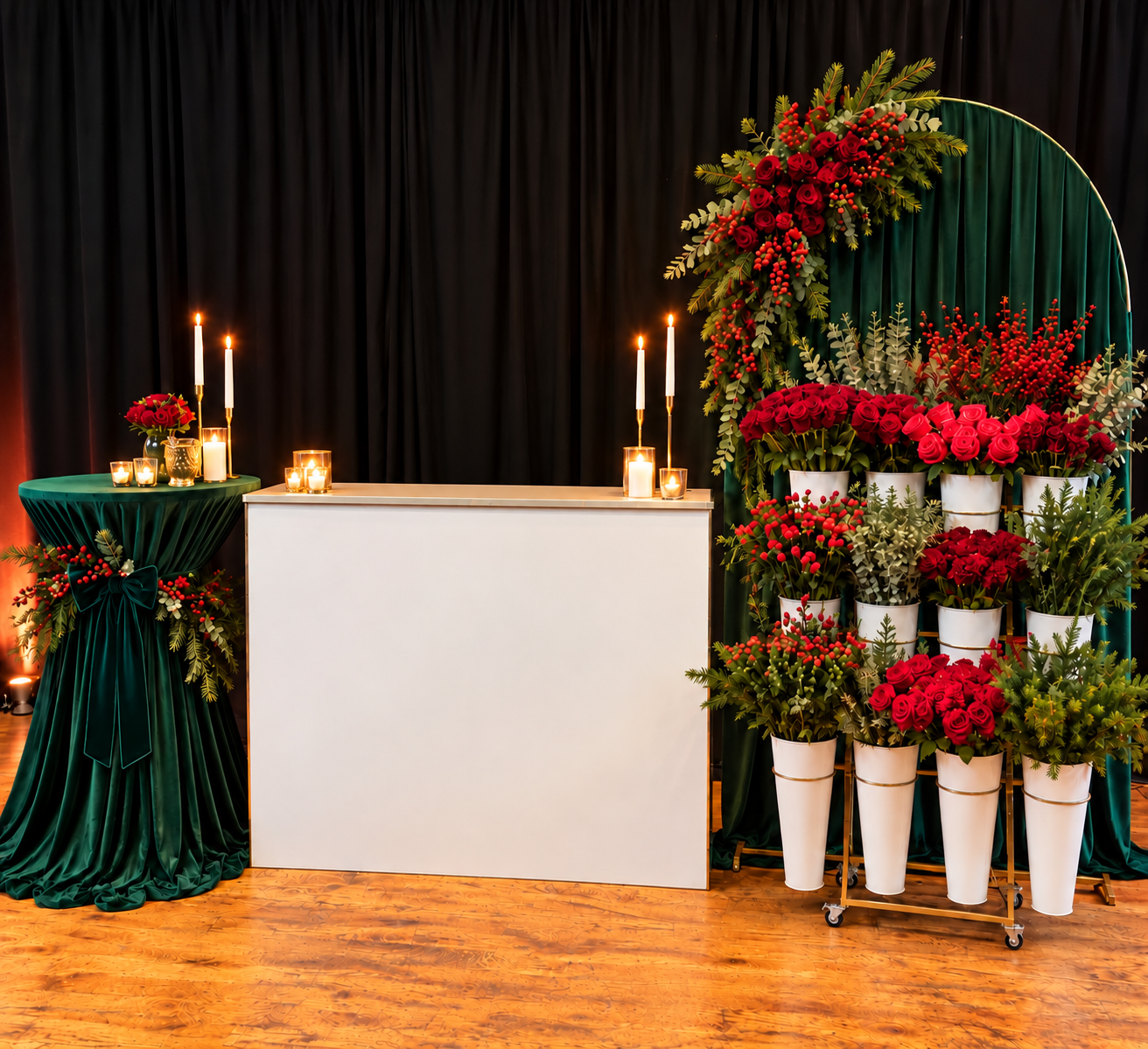 Holiday Flower Bar styling concept: white flower bar with candles, a draped emerald velvet highboy, an emerald arch backdrop with red roses and berries, and a gold bouquet stand of red roses and greenery